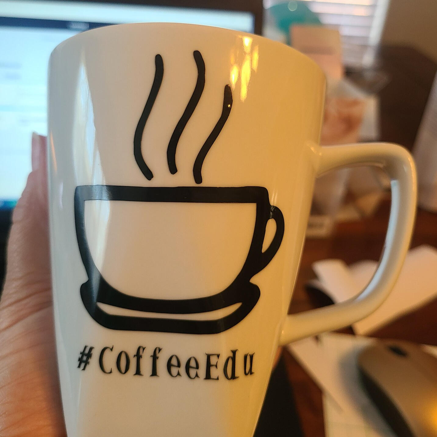 white mug with #CoffeeEDU and icon of coffee mug with steam